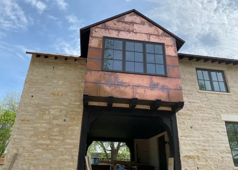 Copper metal panel facade on a stone building for Metal Roof Coating in Leesville