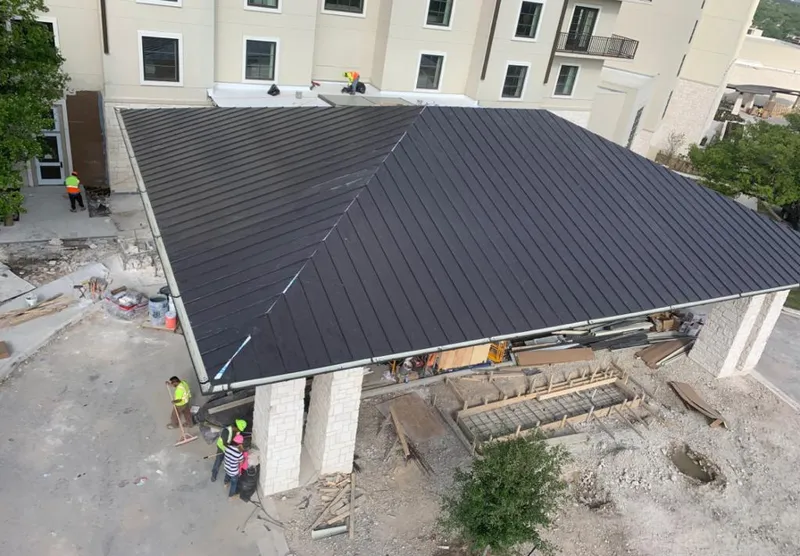 Metal roofing installation team working on a commercial building in Leesville