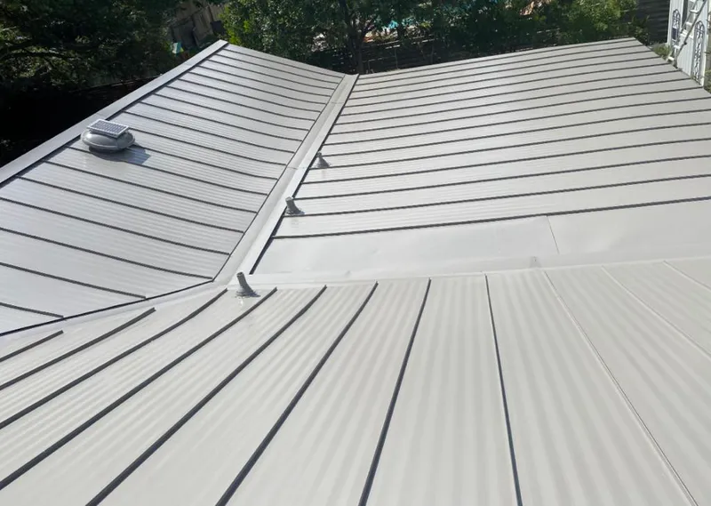Solar attic fan installed on a metal roof for Roof Ventilation in Leesville